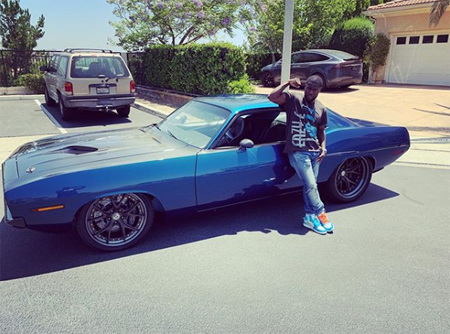 Kevin Hart with his muscle car.